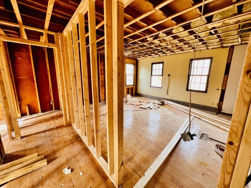 Gutted room with exposed wood framing ready for insulation