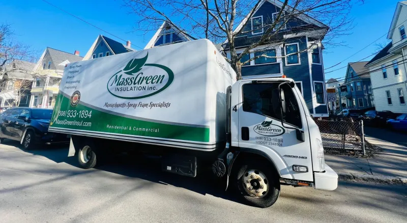 Mass Green Insulation truck parked on a residential street
